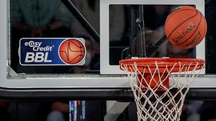 Basketball - Berlin: Ein Ball fliegt auf den Korb zu, an dem ein Logo der Basketball-Bundesliga klebt. Foto: Axel Heimken/dpa/Symbolbild