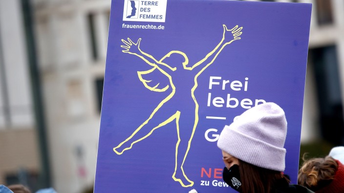 Menschenrechte - Berlin: Eine Frau trägt ein Schild bei einer Aktion von Terre des Femmes am Tag gegen Gewalt an Frauen in Berlin. Foto: Carsten Koall/dpa/Symbolbild