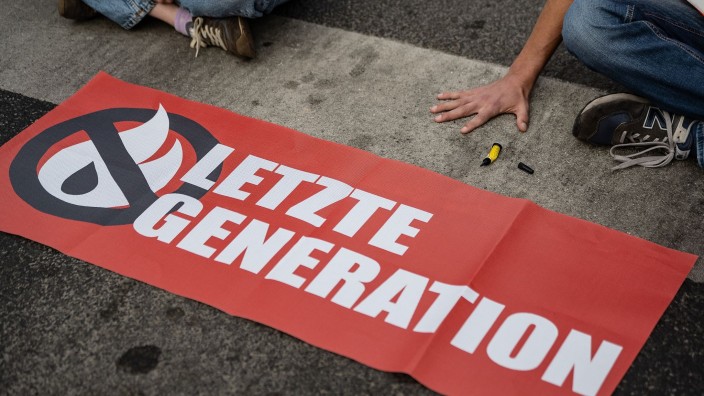 Klima - Berlin: Ein Aktivist der Gruppe "Letzte Generation", blockiert eine Kreuzung. Foto: Swen Pförtner/dpa/Symbolbild