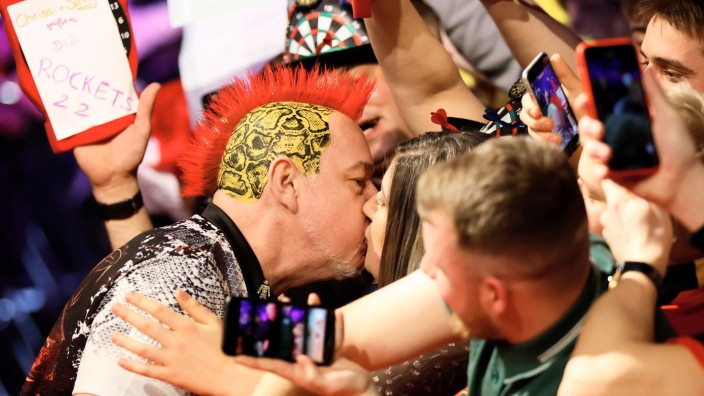 Darts - Berlin: Peter Wright aus England kommt in die Halle und küsst einen Fan. Foto: Jean-Marc Wiesner/dpa