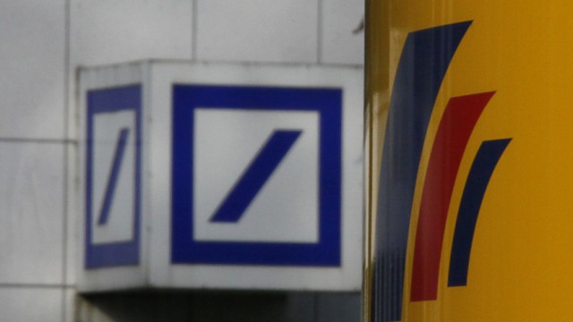 The logos of Deutsche Bank and Postbank are pictured in front of the Postbank headquarters in Bonn