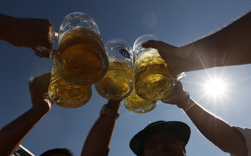 People toast with beer mugs at Munich's Oktoberfest