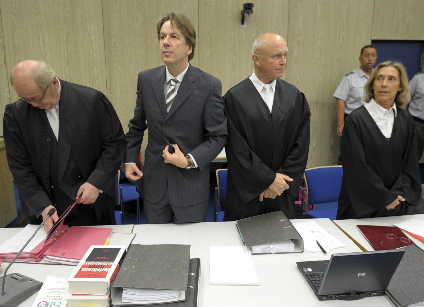 Swiss meteorologist and TV weather host Kachelmann stands with his lawyers during the fifth day of his trial at the country court in Mannheim