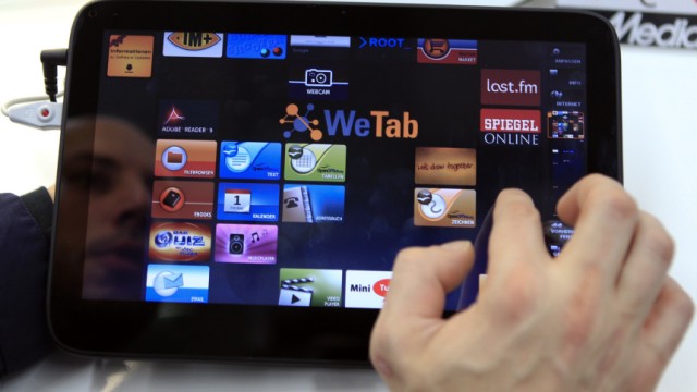 A customer examines the WeTab tablet computer during the first day of its sales in an electronics supermarket in Berlin