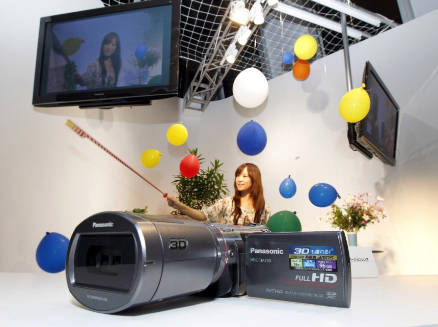 A model poses to demonstrate Panasonic's 3D video camcorder at CEATEC JAPAN 2010 in Chiba