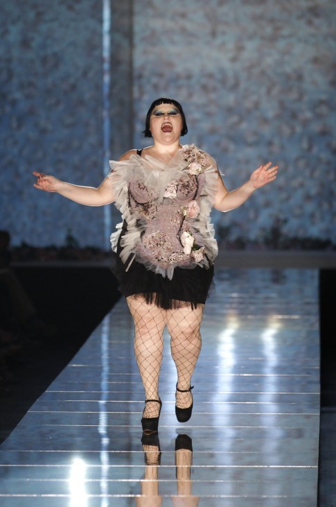 Singer Beth Ditto of U.S. band Gossip presents a creation by French designer Jean-Paul Gaultier as part of his Spring/Summer 2011 fashion show in Paris