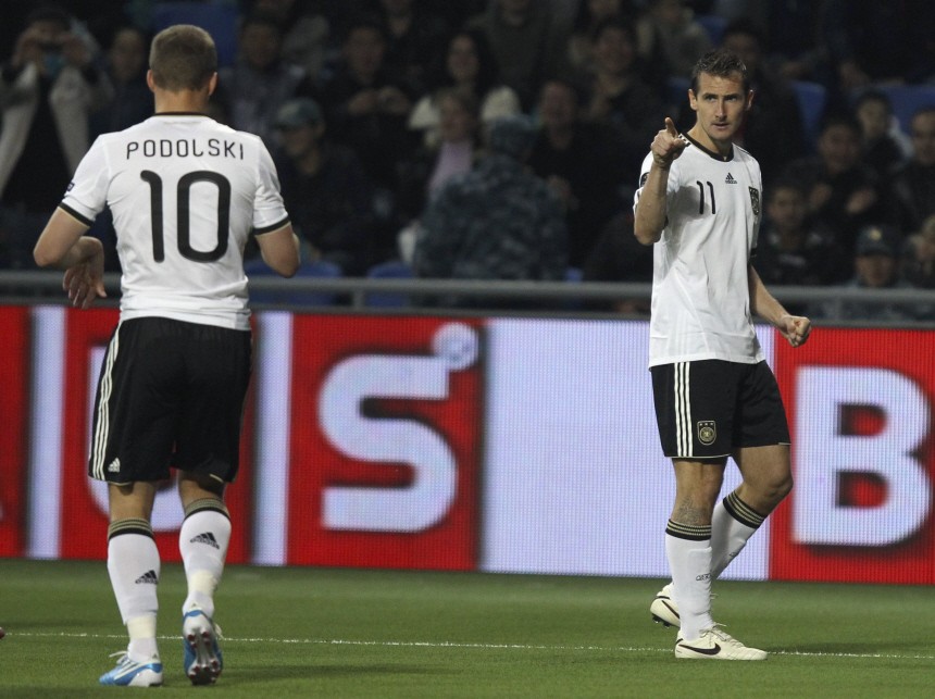 Germany's Klose points at team mate Podolski after scoring a goal against Kazakhstan during their Euro 2012 qualifying soccer match at the Astana Arena in Astana
