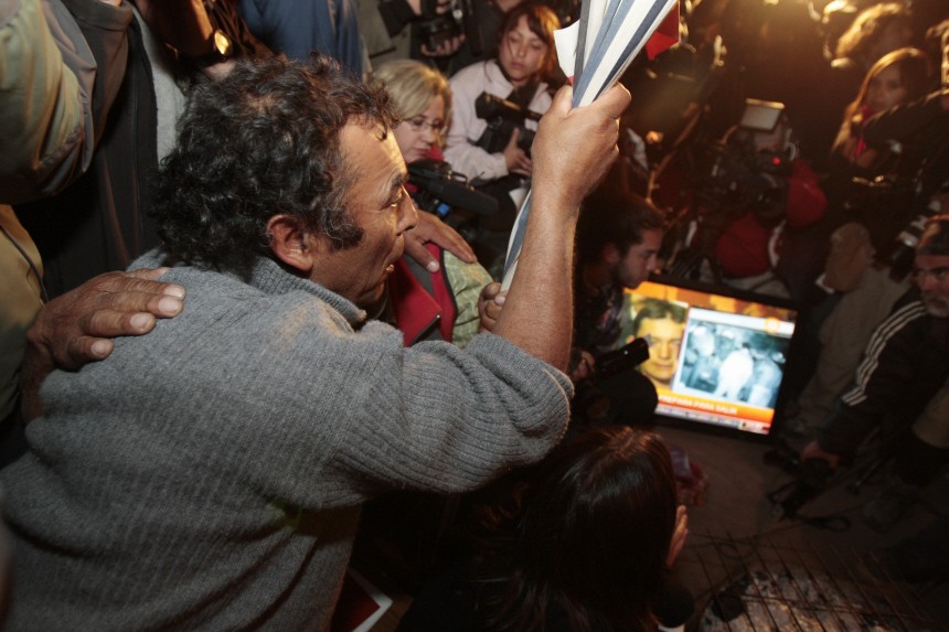 Alfonso Avalos, father of miner Florencio Avalos, watches with family and other miners' families the rescue of his son Florencio Avalos  in Copiapo