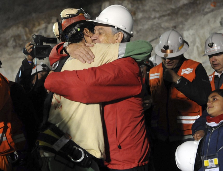 Chilean miner Florencio Avalos reaches the surface as the first of the 33 trapped miners to be hoisted to safety in Copiapo