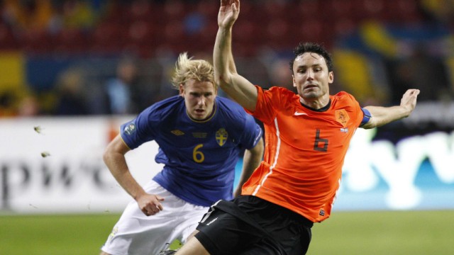 Sweden's Toivonen tackles Netherlands' Van Bommel during their Euro 2012 qualifying soccer match in Amsterdam