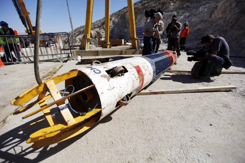 A cameraman films one of the 'Phoenix' rescue capsule, a day after all the 33 trapped miners were rescued at the San Jose mine in Copiapo