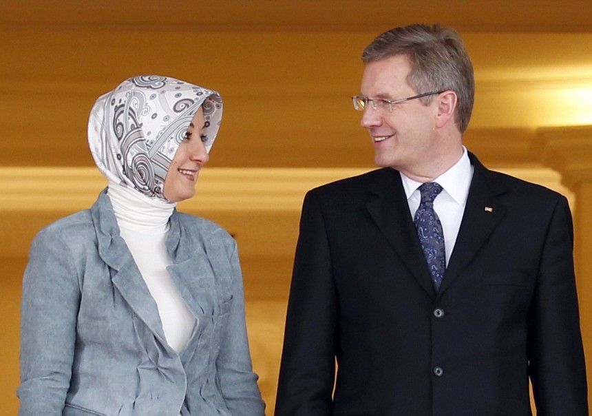 Germany's President Christian Wulff chats with Hayrunnisa Gul, wife of Turkey's President Abdullah Gul, as they pose during a welcoming ceremony at the Presidential Palace of Cankaya in Ankara