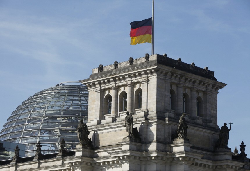 The German national flag flies half-mast atop the Reichstag in Berlin