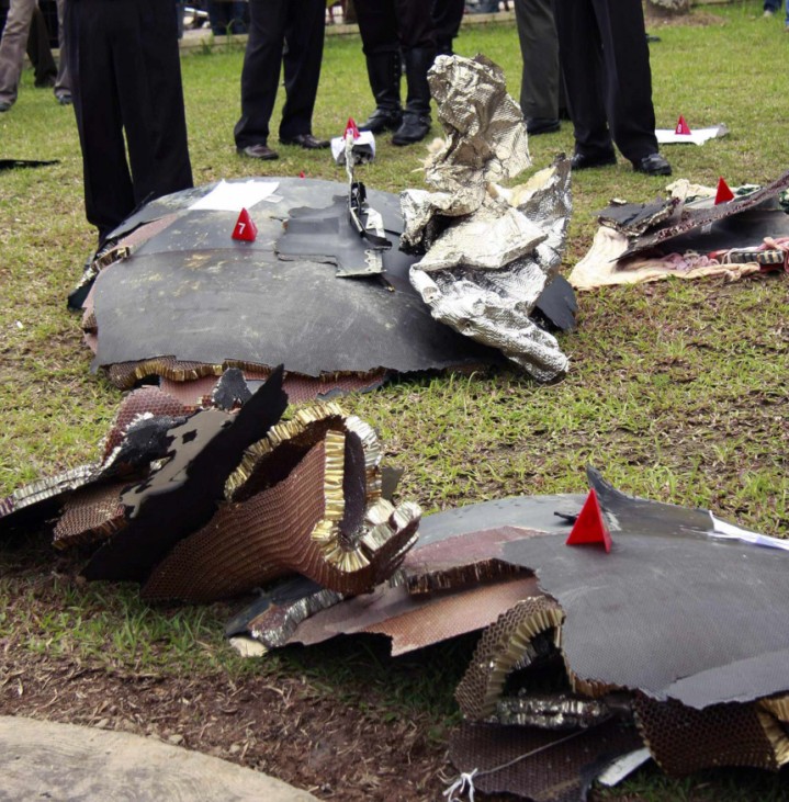 Indonesian police examine fallen debris from a Qantas jet collected from several areas on Batam island, an Indonesian territory near Singapore