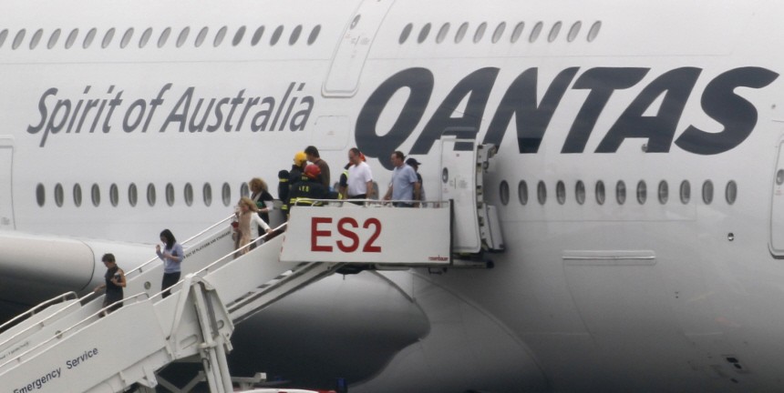 Passengers leave a Qantas Airways 380 passenger plane flight QF32 after it made an emergency landing at Changi airport in Singapore