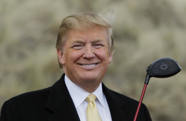 U.S. property mogul Trump holds a golf club during a media event on the sand dunes of the Menie estate