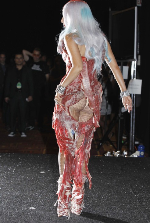 Lady Gaga, wearing a meat dress, poses backstage at the 2010 MTV Video Music Awards in Los Angeles, California
