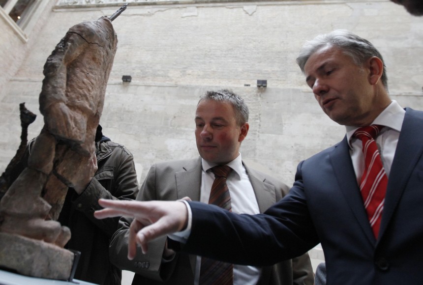Berlin Mayor Wowereit and head of Berlin Museum for Prehistory and Early History Wemhoff inspect sculpture that was discovered during archaeological excavations in Berlin