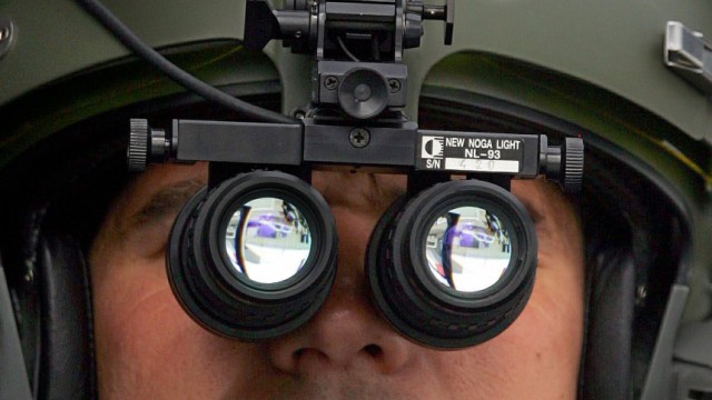 A French pilot tests a new European night vision binoculars on board a Swedish helicopter at the Paris Air Show at le Bourget