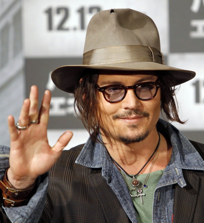 U.S. actor Depp waves at a photo session prior to a news conference to promote his movie 'Public Enemies' in Tokyo