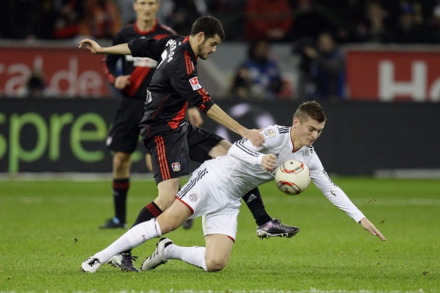 Leverkusen's Barnetta challenges Munich's Kroos during their German Bundesliga soccer match in Leverkusen