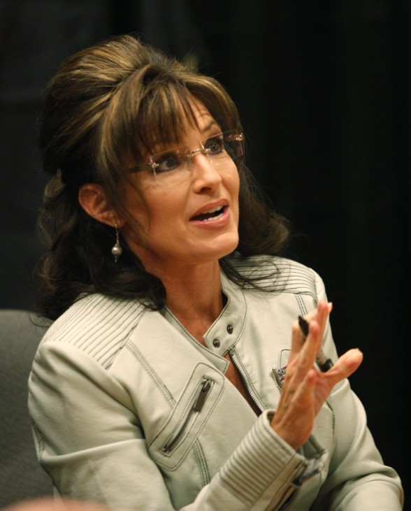 Former Alaska Governor Sarah Palin signs her book during the first stop of her book tour 'American by Heart: Reflections on Family, Faith and Flag' in Phoenix,