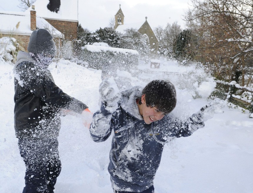 Youths throw snowballs in Stamford Bridge
