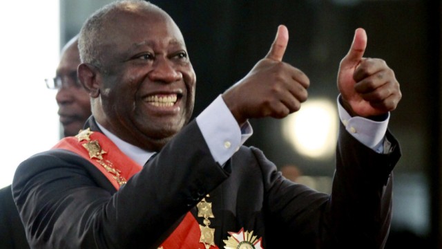 Ivory Coast's President Laurent Gbagbo flashes two thumbs-up during his inauguration at the presidential palace in Abidjan