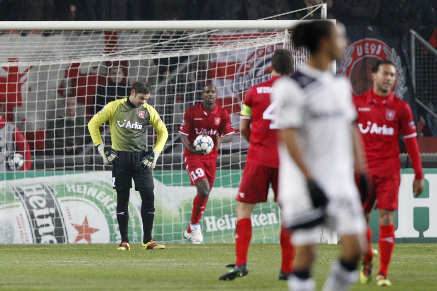 FC Twente's Sander Boschker and teammate  Douglas react after their own goal during their Champions League Group A soccer match against Tottenham Hotspur in Enschede