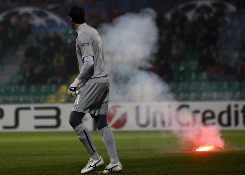 Spartak Moscow's goalkeeper Andriy Dykan walks away from a fire cracker during the Champions League Group F soccer match against Zilina in Zilina