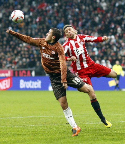 Tymoshchuk of Bayern Munich is challenged by Kruse of FC St Pauli during their German Bundesliga first division soccer match in Munich
