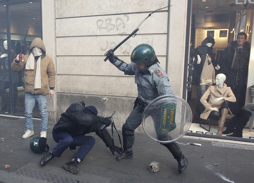 Demonstrators fight with Guardia di Finanza police officers during anti-government clashes near the parliament building in Rome