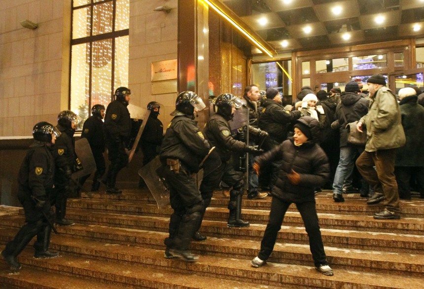 Riot policemen scuffle with foreign journalists in front of hotel they are staying in central Minsk