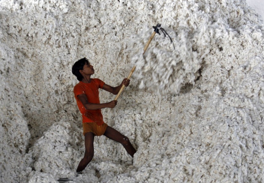 An employee works inside a cotton factory at Adraj village