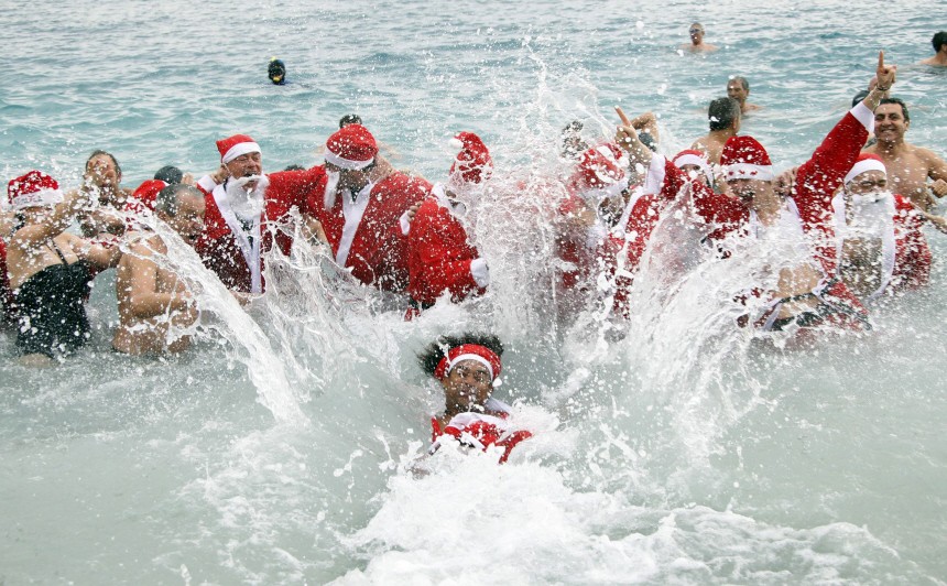 Swimmers dressed as Santa Claus take part in the traditional Christmas bath in Monaco