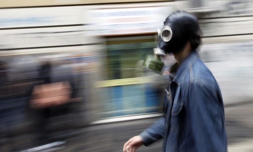 A student wears a gas mask during demonstration in Rome