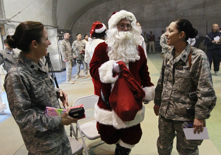 A U.S. soldier dressed up as Santa Claus distributes gifts to other soldiers during Christmas celebrations at Bagram air field, north of Kabul