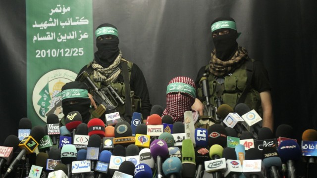 Members of Al-Qassam brigades, the armed wing of the Hamas movement, take part in a news conference in Gaza City