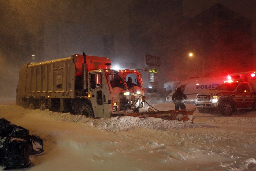A driver of a snow plow stops to render assistance to the driver of a stuck ambulance during a snow storm in the Brooklyn borough of New York