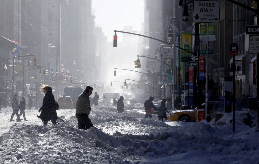 People walk through the snow on 7th Avenue in New York
