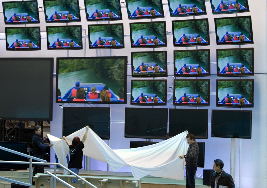 Workers set up a display of televisions at the Panasonic booth in preparation for the CES at the Las Vegas Convention Center in Las Vegas