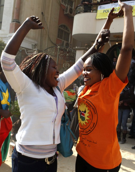 Southern Sudanese refugees cheer for the separation of south Sudan in front of a polling station in Cairo