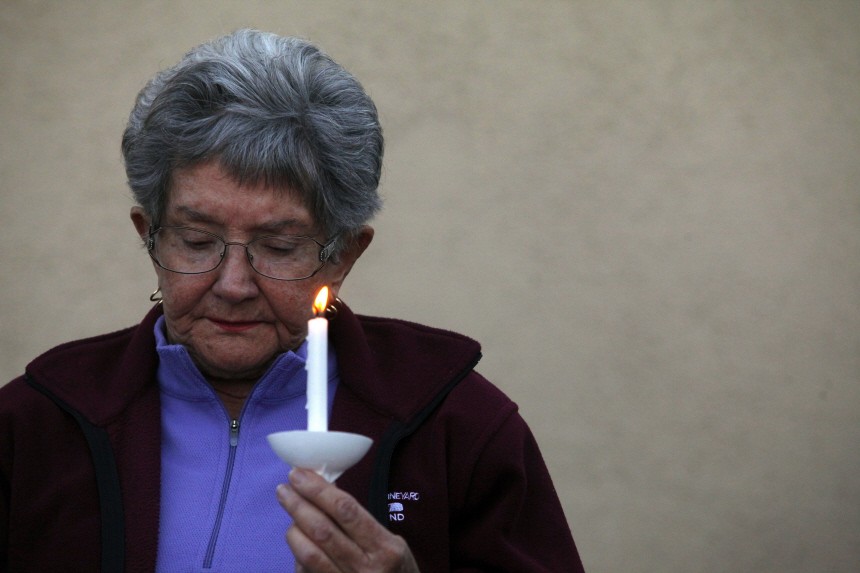 A woman takes part in a prayer vigil in response to Saturday's shooting of U.S Representative Gabrielle Giffords among others at a Safeway in Tucson, Arizona
