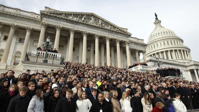 Members of Congress and other Capitol Hill staffers observe a moment of silence on the steps of the U.S. Capitol for Arizona Congresswoman Giffords in Washington