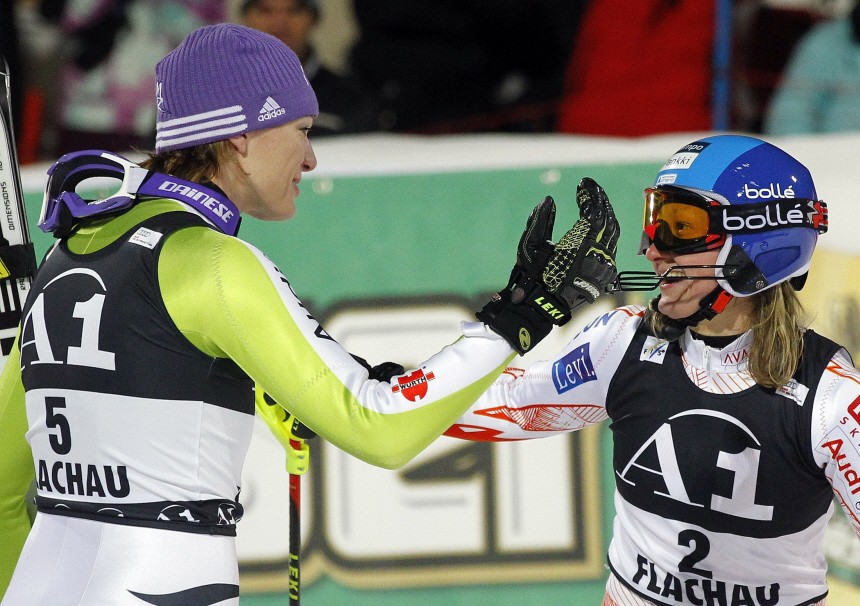 Germany's Riesch and Finland's Poutiainen react after sharing the first place in the women's Alpine skiing slalom World Cup race in Flachau