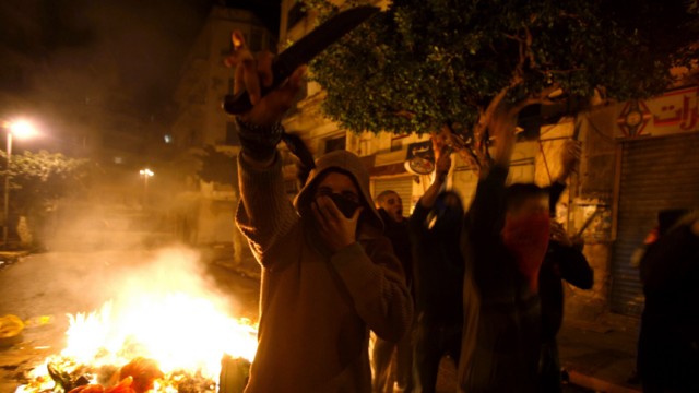 Algerian protesters hold knives during clashes with police in Bab el-Oued district of Algiers