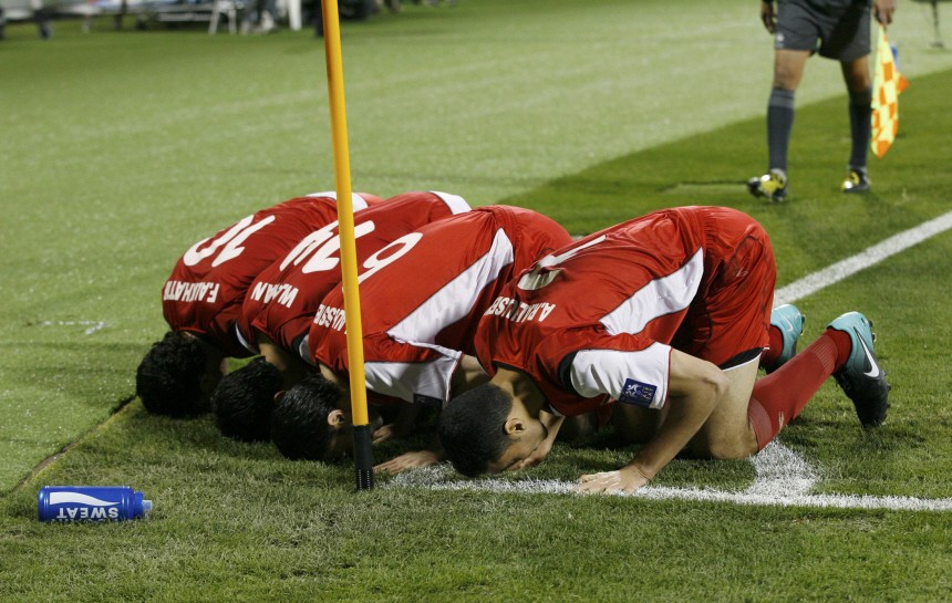 Syria's players celebrate after scoring against Japan during their 2011 Asian Cup Group B soccer match in Doha