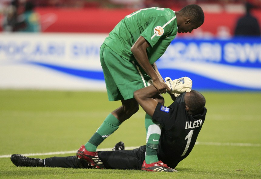 Saudi Arabia's Manaf assists teammate Waleed after they lost to Jordan during their 2011 Asian Cup Group B soccer match in Doha