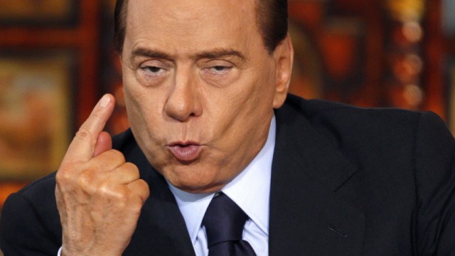 File photo of Italy's Prime Minister Berlusconi as he gestures during his final news conference of the year in Rome