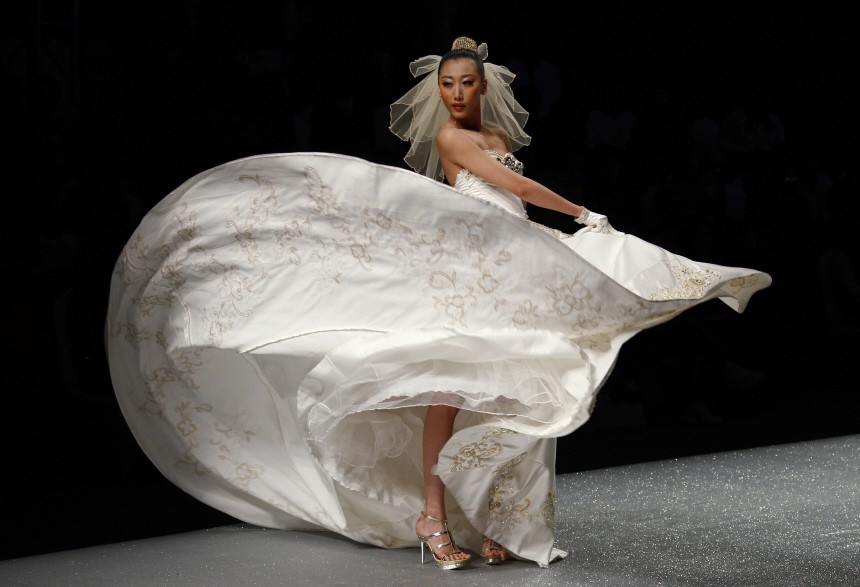 A model presents a creation for a wedding dress collection by designer Tsai Meiyue at China Fashion Week in Beijing